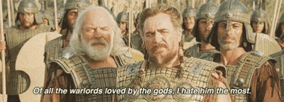A Group Of Men In Armor Are Standing Next To Each Other And One Of Them Is Talking About The Warlords Loved By The Gods GIF