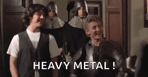 A Group Of Men In Armor Are Standing Next To Each Other In A Room And One Of Them Is Saying `` Heavy Metal ! '' GIF