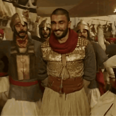 A Group Of Men In Armor Are Standing Together GIF