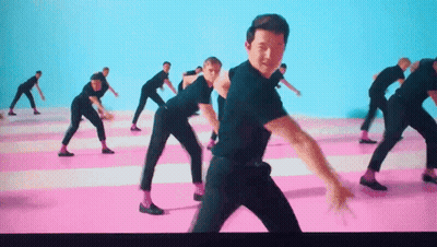 A Group Of Men In Black Shirts And Pink Socks Are Dancing On A Pink And Blue Floor . GIF