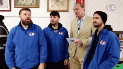 A Group Of Men In Blue Jackets With Lc On Them GIF