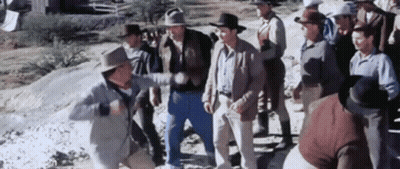 A Group Of Men In Cowboy Hats Are Standing Next To Each Other In A Field . GIF