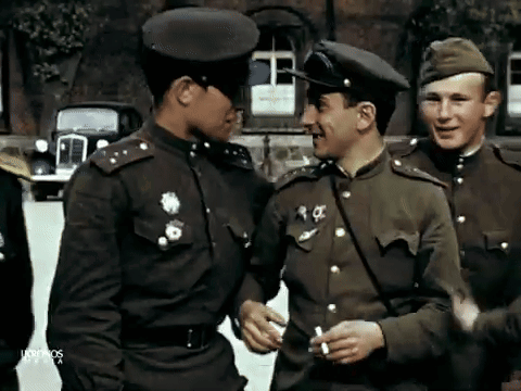 A Group Of Men In Military Uniforms Are Standing In Front Of A Building With The Word Ultimos On The Bottom GIF