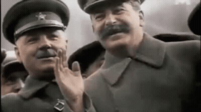 A Group Of Men In Military Uniforms Are Waving At Each Other In A Crowd . GIF