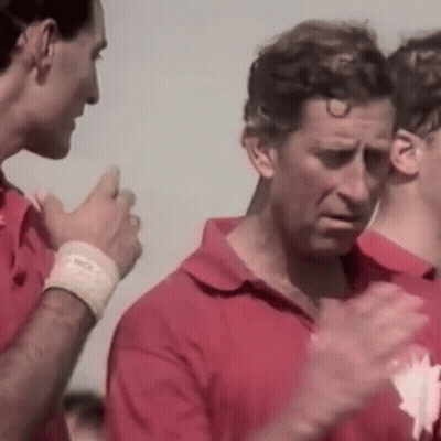 A Group Of Men In Red Shirts Are Standing Next To Each Other Clapping Their Hands . GIF