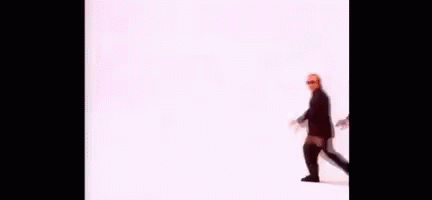 A Group Of Men In Suits And Sunglasses Are Walking In A Line On A White Background . GIF