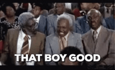 A Group Of Men In Suits And Ties Are Sitting In A Stadium . GIF