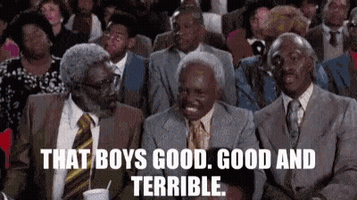 A Group Of Men In Suits And Ties Are Sitting In A Theatre . GIF
