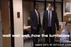 A Group Of Men In Suits And Ties Are Standing In An Office . GIF