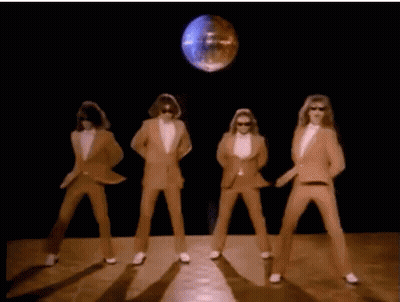 A Group Of Men In Suits And White Gloves Are Dancing In Front Of A Disco Ball . GIF