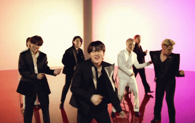 A Group Of Men In Suits Are Dancing Together On A Red Floor GIF