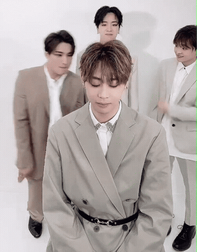 A Group Of Men In Suits Are Posing For A Picture . GIF