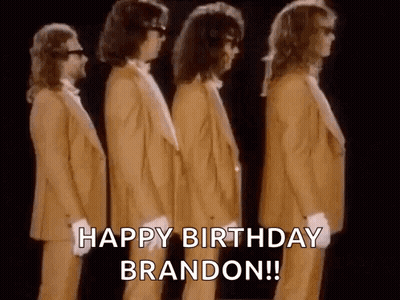 A Group Of Men In Suits Are Standing Next To Each Other In A Row And Saying `` Happy Birthday Brandon '' . GIF
