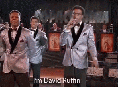 A Group Of Men In Suits Are Standing Next To Each Other On A Stage . GIF
