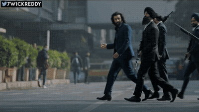A Group Of Men In Suits Are Walking Down A Street With A Twitter Logo In The Corner GIF
