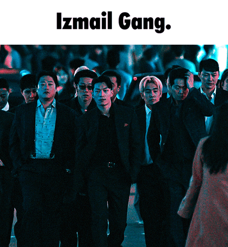 A Group Of Men In Suits Are Walking Down A Street With The Words Izmail Gang Below Them GIF