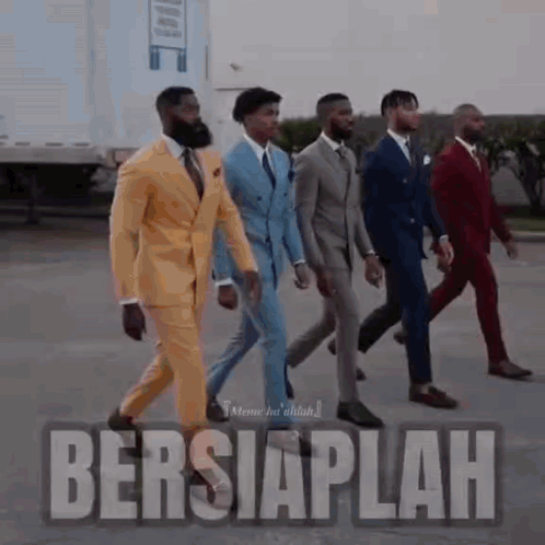 A Group Of Men In Suits Are Walking In A Line . GIF