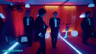 A Group Of Men In Tuxedos Are Dancing In A Room With The Words Halfaliveco In The Corner GIF