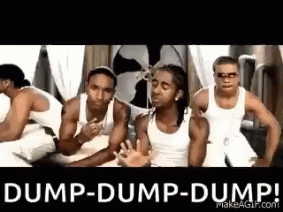 A Group Of Men In White Tank Tops Are Standing Next To Each Other In A Room With A Fan . GIF