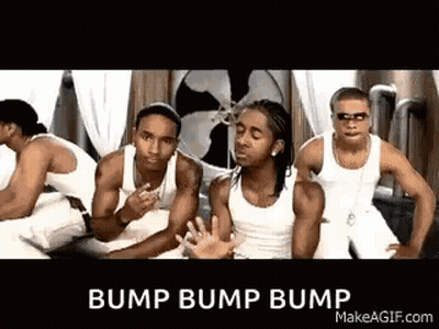 A Group Of Men In White Tank Tops Are Standing Next To Each Other . GIF