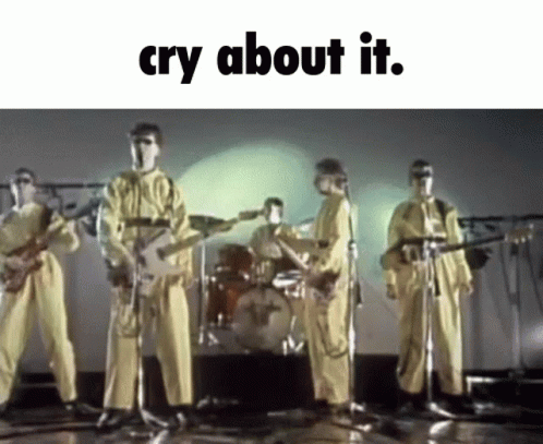 A Group Of Men In Yellow Jumpsuits Are Playing Guitars And Singing Into Microphones With The Words Cry About It Below Th GIF