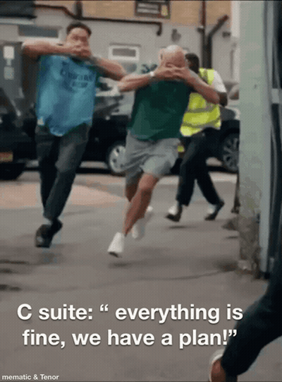 A Group Of Men Running Down A Street With The Words " C Suite Everything Is Fine We Have A Plan " GIF