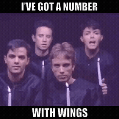 A Group Of Men Singing In A Choir With Candles In Their Hands GIF