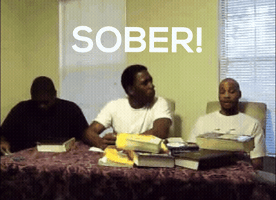 A Group Of Men Sit At A Table With The Word Sober Written On The Screen GIF