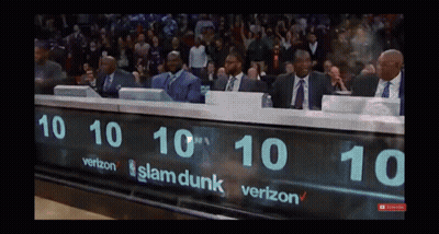 A Group Of Men Sit Behind A Scoreboard That Says Slam Dunk On It GIF