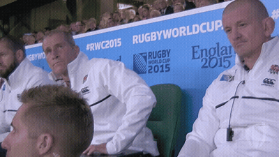 A Group Of Men Sitting In Front Of A Rugby World Cup 2015 Sign GIF