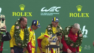 A Group Of Men Stand On A Podium With Rolex Advertisements Behind Them GIF