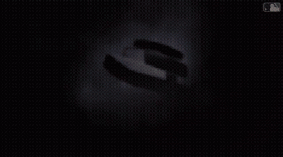 A Group Of Men Standing Around A Table With Cardinals.com Written On The Wall Behind Them GIF