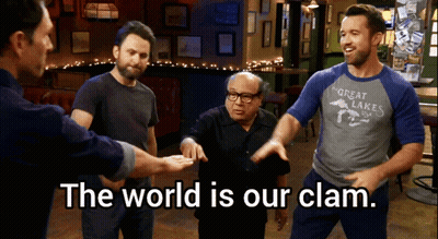 A Group Of Men Standing In A Room With The Words " The World Is Our Clam " GIF