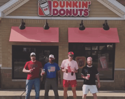 A Group Of Men Standing In Front Of A Dunkin Donuts GIF