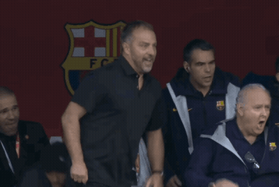 A Group Of Men Standing In Front Of A Sign That Says ' Fcb ' On It GIF