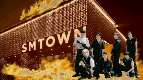 A Group Of Men Standing In Front Of A Smtown Sign GIF