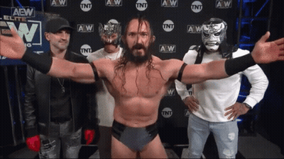 A Group Of Men Standing In Front Of A Wall That Says Aew On It GIF