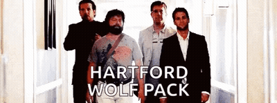 A Group Of Men Standing Next To Each Other In A Hallway With The Words Hartford Wolf Pack On The Bottom . GIF