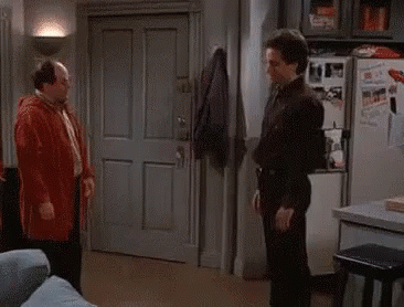 A Group Of Men Standing Next To Each Other In A Living Room Talking To Each Other . GIF