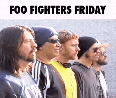 A Group Of Men Standing Next To Each Other In A Row With The Words Foo Fighters Friday Written Above Them . GIF