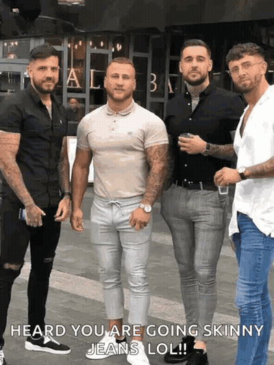 A Group Of Men Standing Next To Each Other On A Sidewalk With The Caption Heard You Are Going Skinny Jeans Lol . GIF