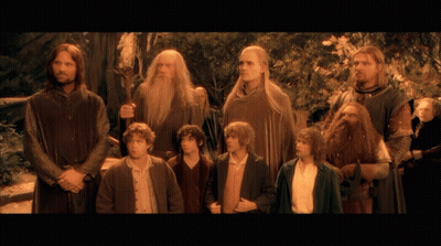 A Group Of Men Standing Next To Each Other With One Holding A Sword GIF