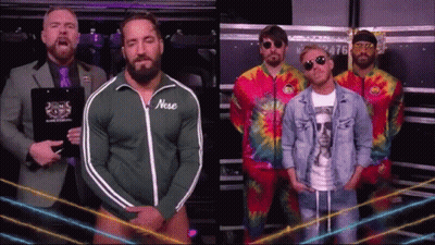 A Group Of Men Standing Next To Each Other With One Wearing A Green Jacket With The Word Nose On It GIF