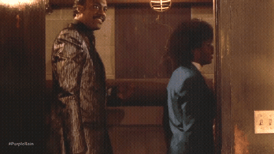 A Group Of Men Standing Next To Each Other With #Purplerain Written On The Bottom Right GIF