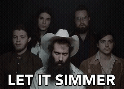 A Group Of Men Standing Next To Each Other With The Words Let It Simmer Written Above Them GIF