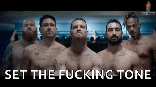 A Group Of Men Standing Next To Each Other With The Words Set The Fucking Tone In The Corner GIF