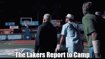 A Group Of Men Standing On A Basketball Court With The Words " The Lakers Report To Camp " Above Them GIF