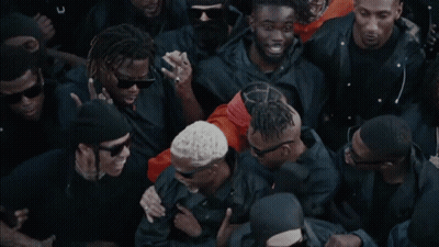 A Group Of Men Wearing Black Jackets And Sunglasses Are Standing Together GIF