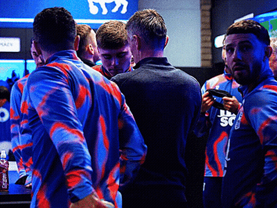 A Group Of Men Wearing Blue And Red Shirts With The Letter S On The Front GIF
