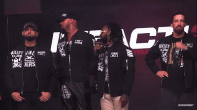 a group of men wearing bullet club shirts stand in front of a sign that says do you wanna fight about it